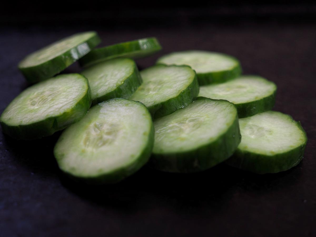 An image of cucumbers sliced and arranged in a salad bowl
